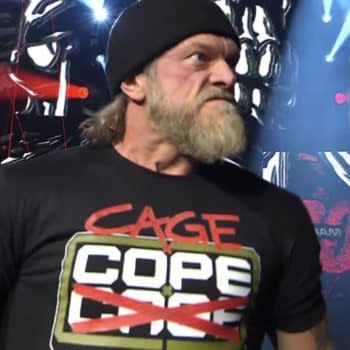 Wrestler Adam Copeland returns from injury at AEW Revolution, wearing a black shirt with bold red and green lettering and a beanie, showcasing an intense expression against a background of dramatic lighting and graphics.