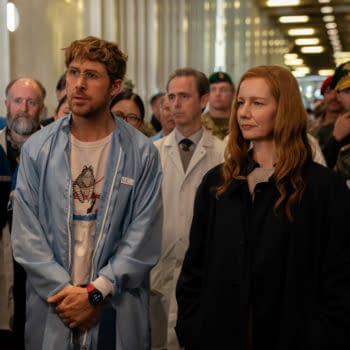 Ryan Gosling as Ryland Grace and Sandra Hüller as Eva Stratt stand among a group of scientists and military personnel, showing a moment of serious discussion on the set of the film Project Hail Mary.
