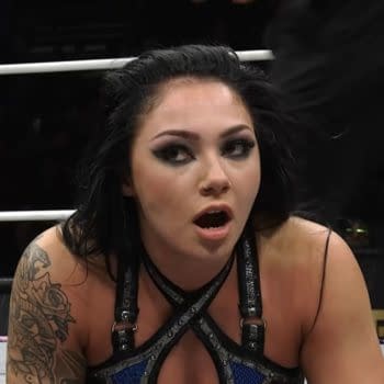 Skye Blue, a wrestler from the Sisters of Sin, shows a shocked expression while reacting to a pin attempt during an AEW Collision match. The wrestling ring is visible in the background.