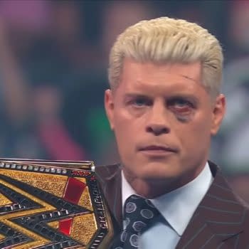 Cody Rhodes stands on WWE SmackDown with the WWE Championship over his shoulder, looking bruised and intense after a battle. His face shows a black eye and a stern expression.