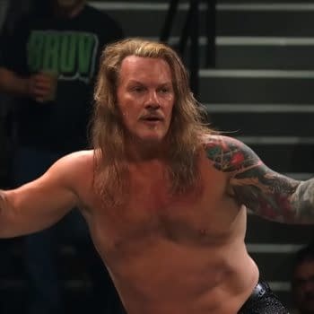Chris Jericho stands in the AEW ring with his arms out and a puzzled expression, seeming to weigh his next move on Collision.