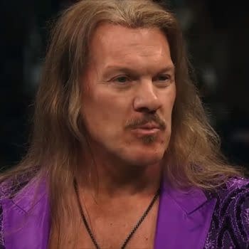 Chris Jericho, wearing a vibrant purple outfit, is featured in a wrestling ring. He has long hair and is giving a serious expression, indicating a dramatic moment.