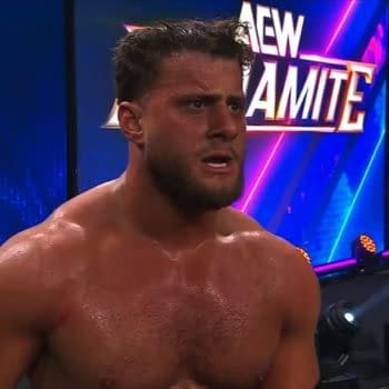 MJF stands shirtless on the AEW Dynamite stage, looking exhausted and frustrated after a match. The AEW logo glows behind him in bright blue and purple lights.