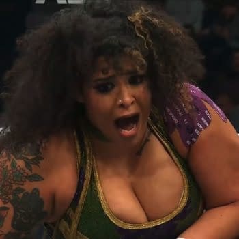 Willow Nightingale, the TBS Champion, appears shocked and intense during a wrestling match against Kamille at AEW Dynamite: Spring Breakthru. Her expressive face and detailed tattoos are visible as she engages in the competition.
