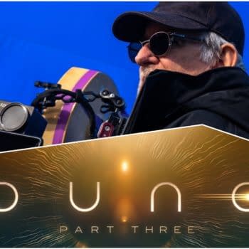 A behind-the-scenes view featuring a filmmaker, dressed in black and wearing sunglasses, seated next to camera equipment. The image includes the logo for 'Dune: Part Three', showcasing sci-fi design elements with glowing text.