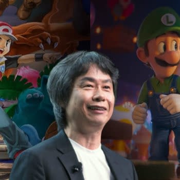 A cartoon-style illustration featuring Shigeru Miyamoto, the creator of Mario, smiling in the foreground, with Luigi, Yoshi, and Toad in the background from 'The Super Mario Galaxy Movie'. The image presents a vibrant and playful scene, highlighting familiar Nintendo characters.