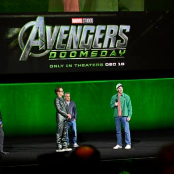 Kevin Feige, Anthony Russo, Joe Russo, Robert Downey Jr., and Chris Evans stand onstage at CinemaCon in front of a large Avengers: Doomsday Marvel Studios title screen.