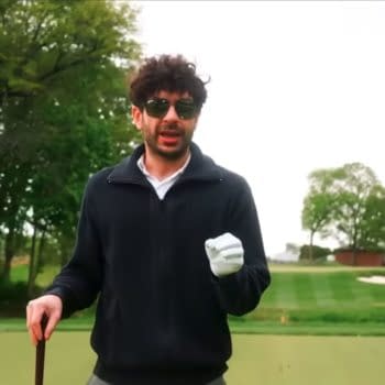 Tony Khan stands on a golf course wearing sunglasses and a white glove, speaking while holding a club. The scene matches AEW Collision: Fairway to Hell.