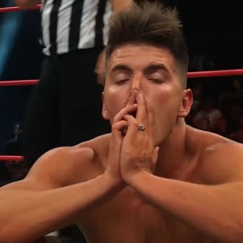 Sammy Guevara pauses in the ring during his AEW Collision match with Darby Allin, hands clasped over his face as he catches his breath.