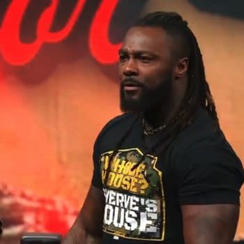 Swerve Strickland stands on the ROH Supercard of Honor stage, staring out at the crowd after attacking Bandido. Red lighting glows behind him as he soaks in the reaction.