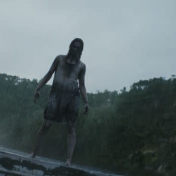 A rain-soaked, eerie figure stands on a rooftop or platform in a dark forest, evoking a creepy Evil Dead Burn horror scene.