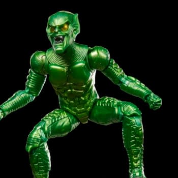 A green Marvel Legends Green Goblin action figure posed against a black background, holding a pumpkin bomb in one hand. The figure is shown in a crouched, menacing stance.