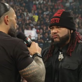 Roman Reigns speaks sternly to Jacob Fatu in the WWE Raw ring during a tense Bloodline confrontation.