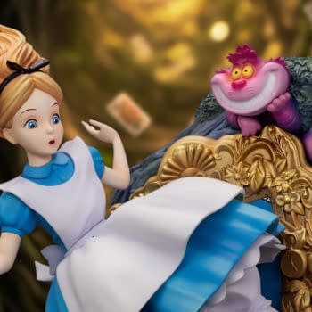 Beast Kingdom Disney Alice in Wonderland statue featuring Alice startled beside the Cheshire Cat perched on an ornate chair. The collectible figure is posed against a dark, whimsical forest backdrop.