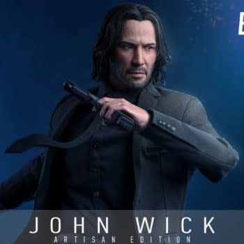 Hot Toys John Wick Artisan Edition Ballerina figure posed in a dark suit, holding a handgun against a blue background. The promo graphic includes the Hot Toys Exclusive badge and Ballerina branding.