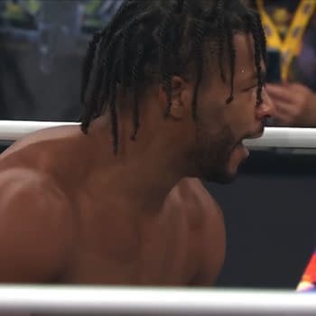 Kevin Knight stands in the AEW ring, shouting in profile during Dynamite. He appears shirtless and focused amid the crowd and ropes.