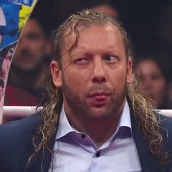 Kenny Omega is seen reacting to crowd cheers during a segment in the ring on AEW Dynamite