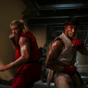 Noah Centineo and Andrew Koji stand back-to-back in fighting stances in a gritty Street Fighter action scene.