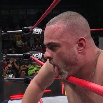 On AEW Collision, wrestler Eddie Kingston hangs one arm over the middle rope, the other grasping the top, as he recovers from a grueling match with Jake Doyle from which he emerged victorious.