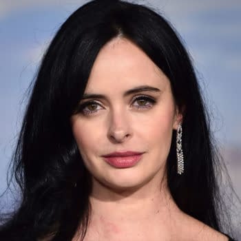 Krysten Ritter poses on the red carpet at the Los Angeles premiere of El Camino: A Breaking Bad Movie, wearing long black hair and dangling earrings.