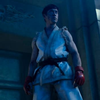 Andrew Koji stands in a blue-lit martial arts gi and red gloves in a Street Fighter scene.