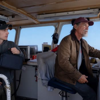 Austin Abrams and Josh Brolin stand in the wheelhouse of a boat in Whalefall, with Brolin steering and Abrams holding a bag.