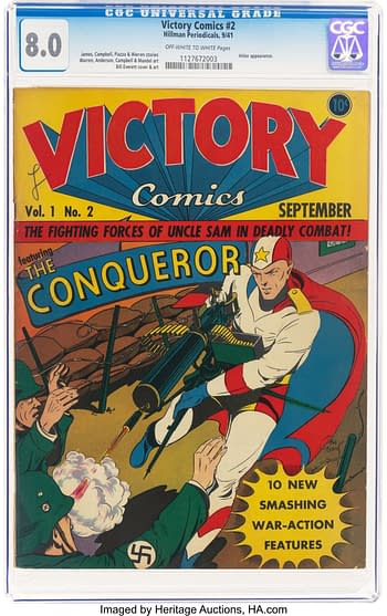 A vintage comic book cover featuring 'Victory Comics #2' from Hillman Publications, highlighting the character 'The Conqueror' in a dynamic combat scene against enemy forces with a backdrop of barbed wire and explosions. The cover has bold red and yellow text with a bright color palette.