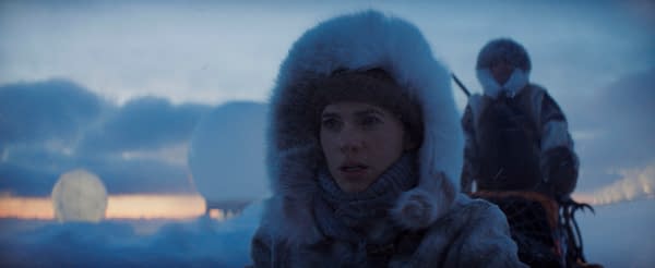 A scene from 'Mission: Impossible - The Final Reckoning' featuring Hayley Atwell as Grace, dressed in warm winter clothing, with a snowy landscape and large white objects in the background.
