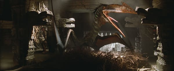 A scene from 'Jurassic World Rebirth' featuring a Quetzalcoatlus, a large flying dinosaur, perched on a nest among ancient ruins. The setting includes atmospheric lighting and stone carvings, enhancing the prehistoric ambiance.