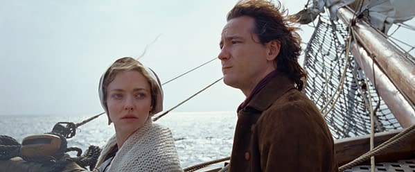 A scene from 'The Testament of Ann Lee' features two characters, a woman with light hair and a shawl, and a man with dark hair and a coat, standing on a ship at sea with the water shimmering in the background.
