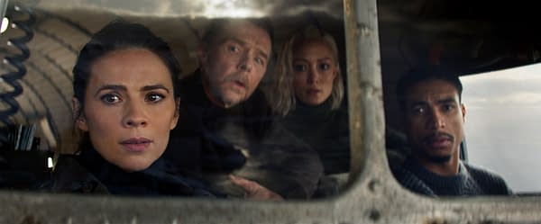 A tense moment from 'Mission: Impossible - The Final Reckoning,' featuring four characters looking out from inside a vehicle, with a dramatic sky in the background.