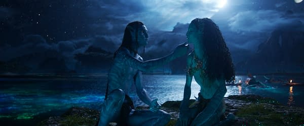 Lo'ak and Tsireya, characters from 'Avatar: Fire and Ash,' share an intimate moment by a serene water's edge under a starry sky, highlighting themes of connection and nature.