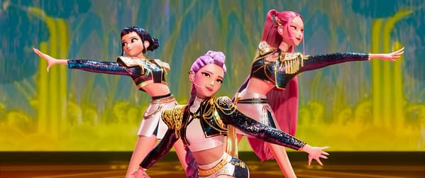 Animated illustration of three K-pop-inspired characters striking dynamic poses on stage, dressed in sparkly outfits with colorful hairstyles, set against a vibrant, fantasy-inspired background. The image represents the 'KPop Demon Hunters' theme, blending music and supernatural elements.