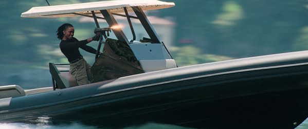 KiKi Layne as Nile is shown on a speedboat, aiming a firearm in an action scene from The Old Guard 2.