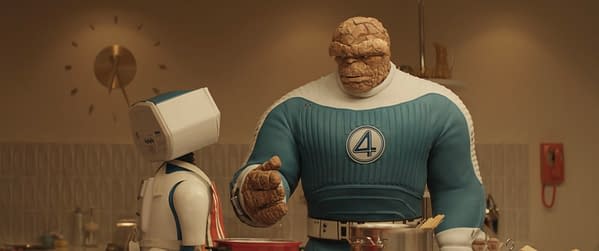 A scene from 20th Century Studios' 'The Fantastic Four: First Steps' featuring H.E.R.B.I.E, a robotic character, next to Ebon Moss-Bachrach as Ben Grimm/The Thing, who has a rocky appearance and is wearing a blue costume with a large number 4. They are in a kitchen setting.