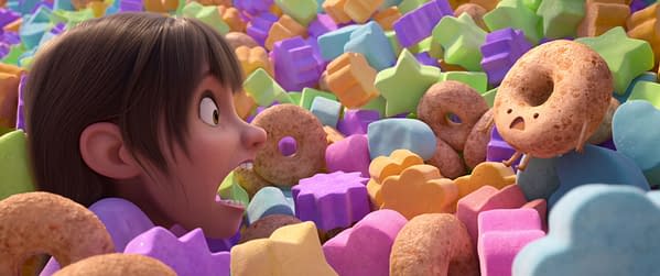 In Your Dreams. A young girl with brown hair looks excited and shocked while surrounded by colorful, star and heart-shaped candies and breakfast foods, including a whimsical donut character with a surprised expression. This scene captures the imaginative chaos of a dreamlike adventure.