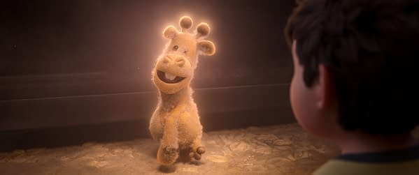 In Your Dreams. A friendly, animated stuffed giraffe with a cheerful expression glows softly as it interacts with a young boy, symbolizing themes of imagination and adventure from the upcoming comedy adventure "In Your Dreams".
