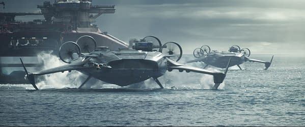 A scene from 'Avatar: Fire and Ash' featuring futuristic hovercrafts maneuvering over water, with a large, industrial structure in the background. The image captures the technological elements of the film, showcasing the action and setting.