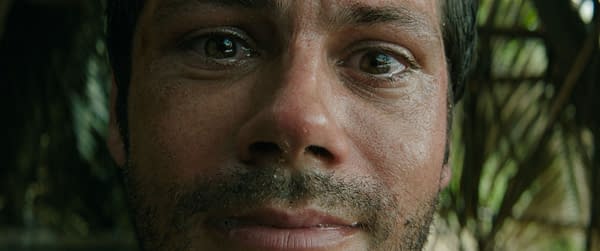 Close-up of a man's face, showing emotional distress, wet skin, and a light beard. The man, portrayed by Dylan O'Brien as Bradley Preston, appears concerned in a scene from the film 'Send Help' by 20th Century Studios.