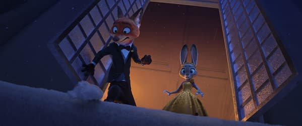 In a scene from the animated film 'Zootopia 2,' Nick Wilde, a fox in a tuxedo, appears surprised while holding a lump of snow, and Judy Hopps, a rabbit in a fancy dress, observes him with concern. The background is dimly lit with a warm glow, suggesting a winter setting.