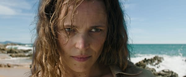 Close-up of Rachel McAdams portraying Linda Liddle in 20th Century Studios' film 'SEND HELP', with a beach and ocean background. Her expression is intense, adding to the dramatic tone of the scene.