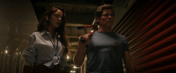 Eiza González portrays Alice alongside James Marsden as Nick in a tense moment from the film 'Mike & Nick & Nick & Alice' by 20th Century Studios, set in a dimly lit storage facility.