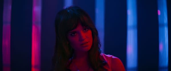 Sophie Thatcher in moody neon lighting, staring ahead in a dark, dramatic scene from Her Private Hell.