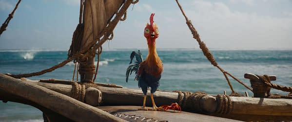 Rooster Heihei stands on a wooden boat deck in Disney's live-action Moana, with the ocean behind him.