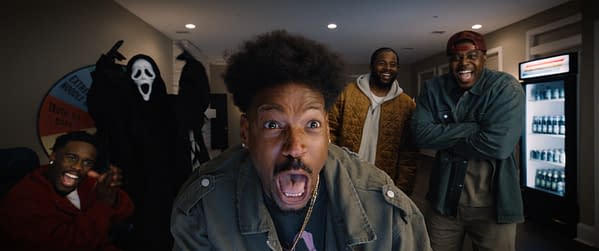 Promotional still from Scary Movie showing Ghostface looming behind three laughing men, with a man in the foreground reacting in shock.