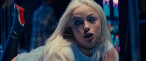 Liv Morgan performs in her 'Trouble' music video, showcasing her singing style and fashion amid an energetic backdrop.