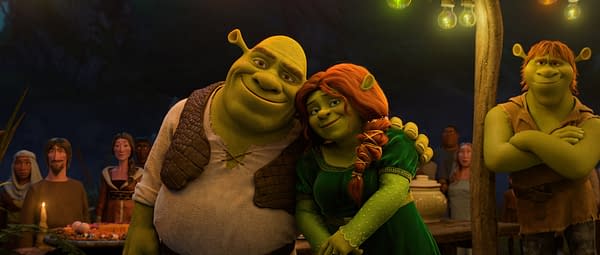 Shrek and Fiona lean close together at a warmly lit gathering in DreamWorks Animation's Shrek 5, with Fergus standing nearby.
