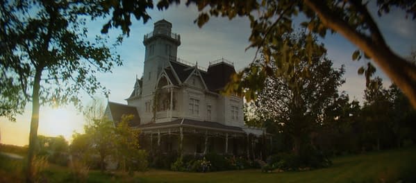 A Victorian-style mansion with intricate architectural details, surrounded by lush greenery and trees, bathed in the warm light of a sunset. This image evokes a sense of enchantment, fitting for the theme of 'Practical Magic 2'.