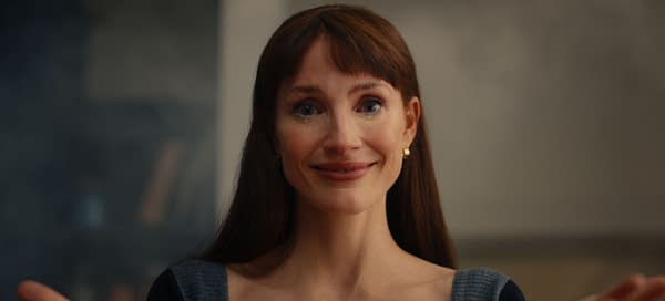 Jessica Chastain as Other Mommy stares forward with a faint, unsettling smile in a close-up from the horror film Other Mommy.