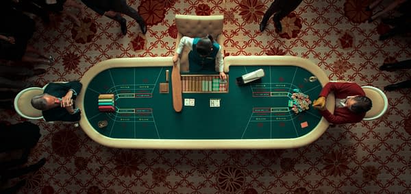 Ballad of a Small Player An overhead view of a casino table where a dealer handles cards and chips, surrounded by players sitting on either side. The table is green with marked betting areas, and there are stacks of colorful chips and playing cards visible.